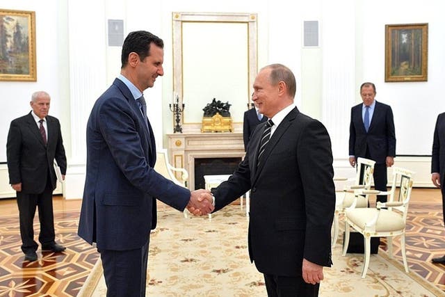 Putin and Assad shake hands in Moscow
