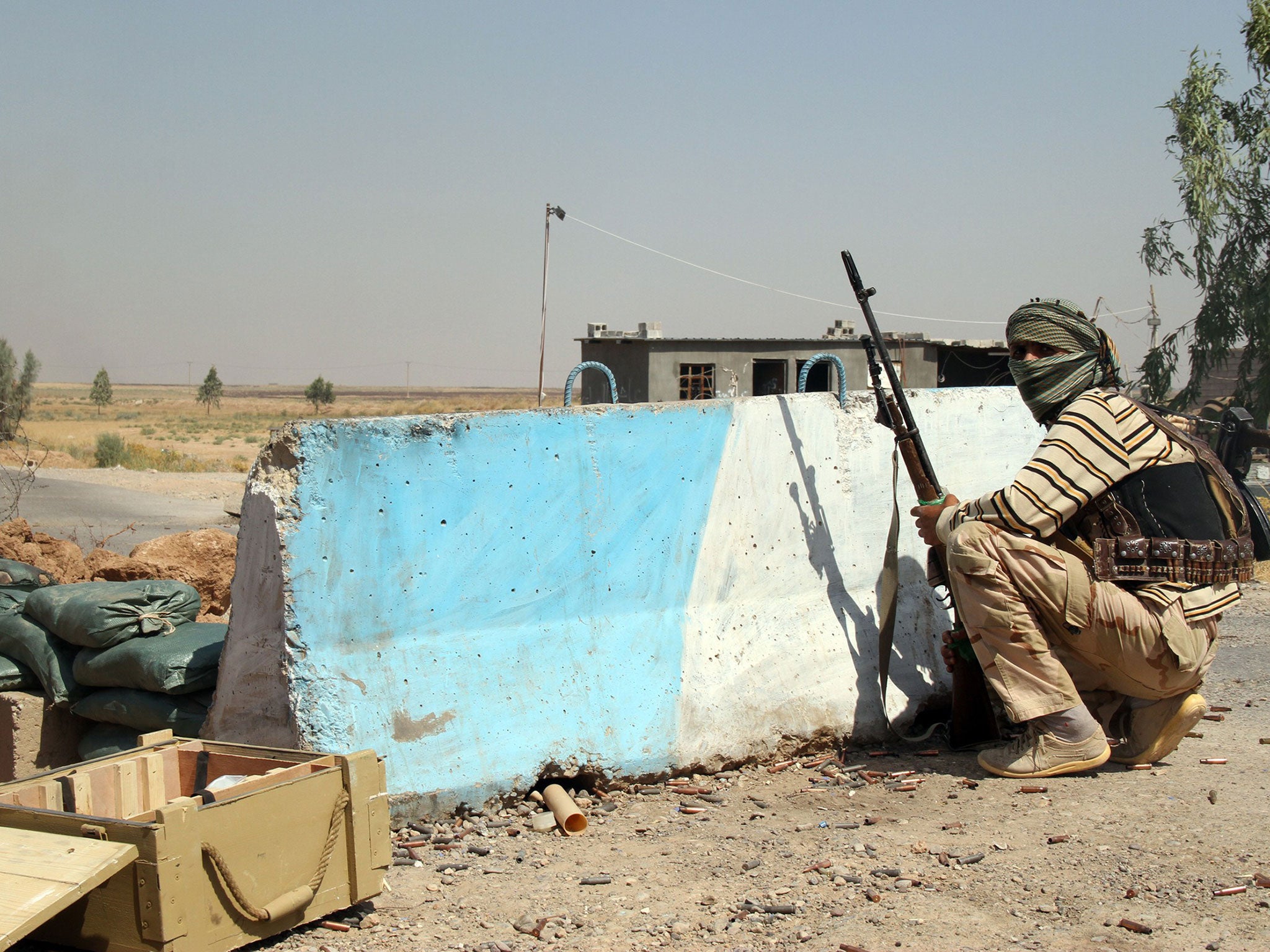 A Iraqi Turkmen Shiite fighter, who volunteered to join the government forces, holds a position on August 4, 2014 in Amerli, some 160 kilometres (100 miles) north of Baghdad. IS fighters launched a blistering offensive on June 9 2014 that saw them capture the Iraqi city of Mosul and move into much of Iraq's Sunni heartland