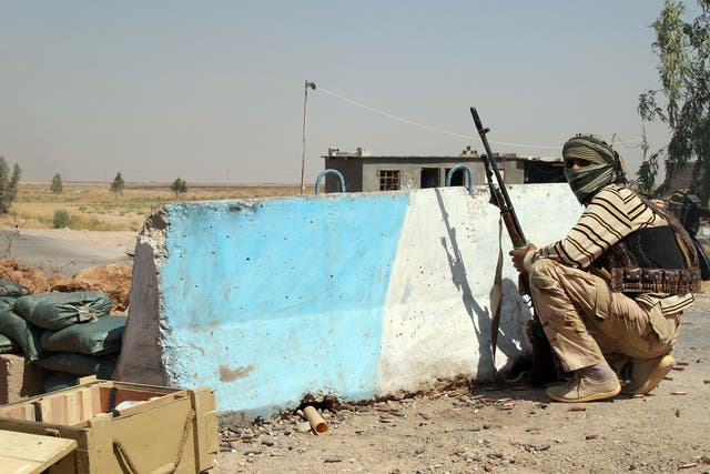 A Iraqi Turkmen Shiite fighter, who volunteered to join the government forces, holds a position on August 4, 2014 in Amerli, some 160 kilometres (100 miles) north of Baghdad. IS fighters launched a blistering offensive on June 9 2014 that saw them capture the Iraqi city of Mosul and move into much of Iraq's Sunni heartland
