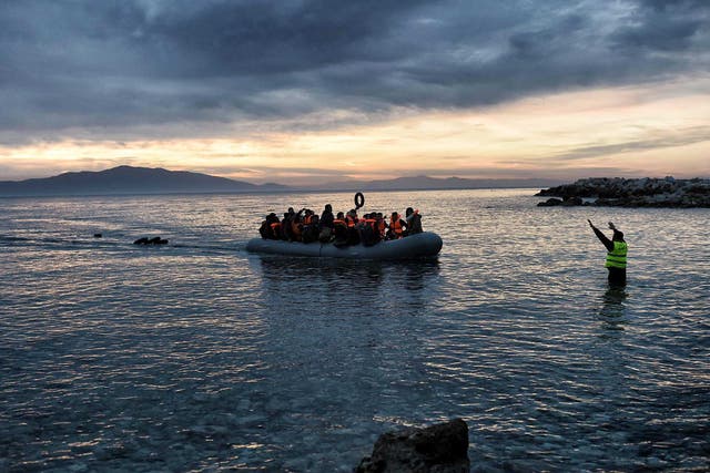 Refugees massed onto an inflatable boat reaching Mytilene, northern island of Lesbos, after crossing the Aegean sea from Turkey, on 17 February, 2016