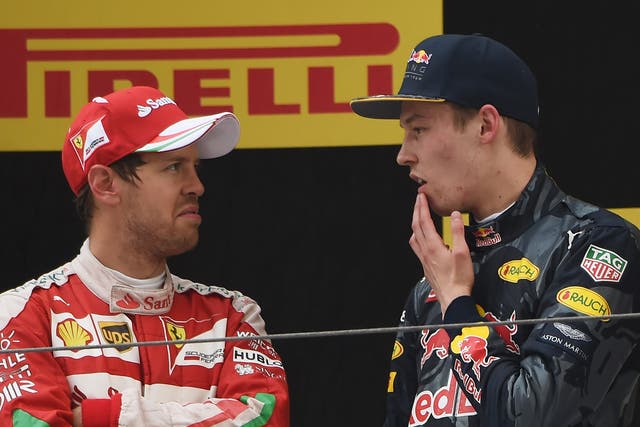 Sebastian Vettel speaks with Daniil Kvyat on the podium after the Chinese Grand Prix