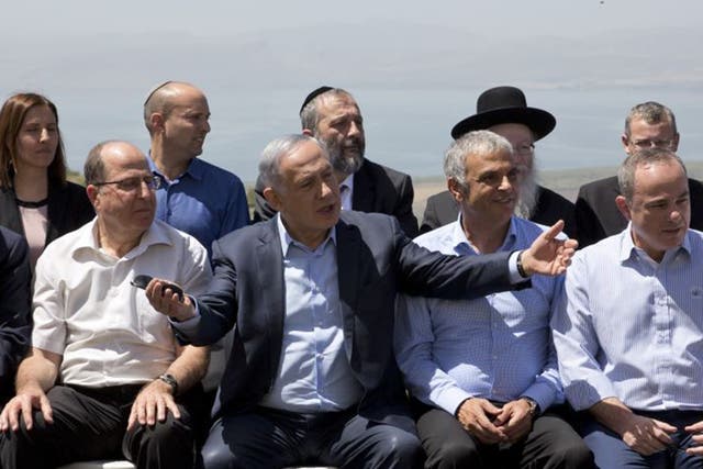 Israeli Prime Minister Benjamin Netanyahu, center, poses with ministers prior to the weekly cabinet meeting in the Israeli controlled Golan Heights