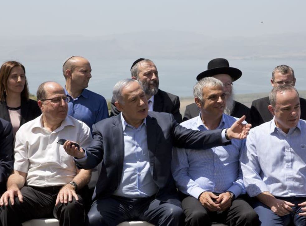 Israeli Prime Minister Benjamin Netanyahu, center, poses with ministers prior to the weekly cabinet meeting in the Israeli controlled Golan Heights