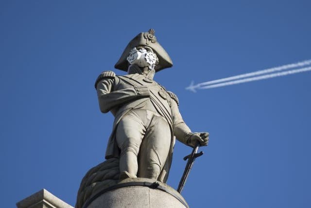 A clean air mask is seen placed on the top of Nelson's Column by Greenpeace activists to protest against air pollution.