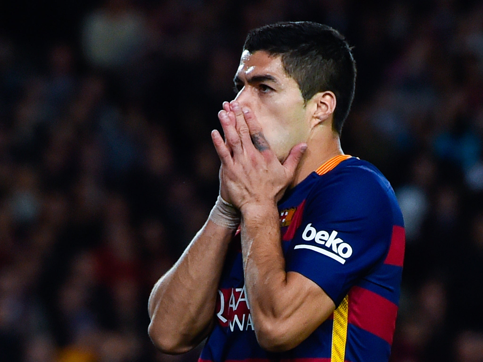Barcelona forward Luis Suarez reacts to missing a chance against Valencia