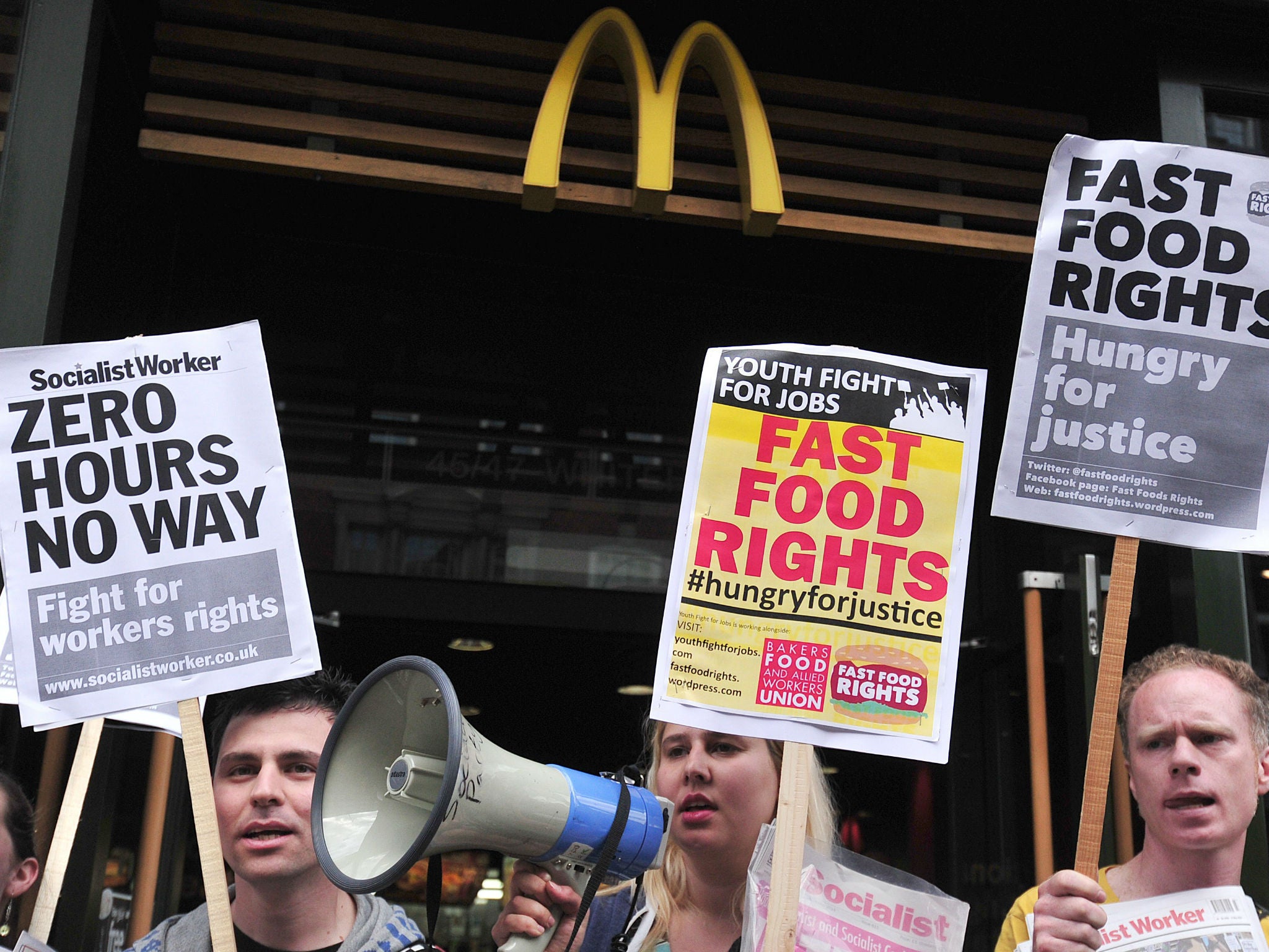 Fast food workers protest for higher wages outside a branch of McDonalds in central London on May 15, 201