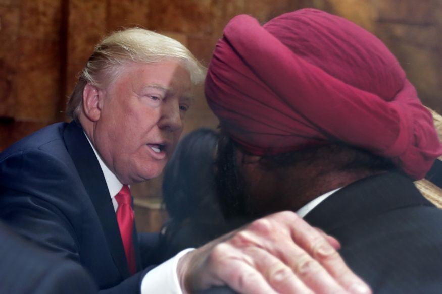 Republican presidential candidate Donald Trump speaks a supporter in New York's Trump Tower building.