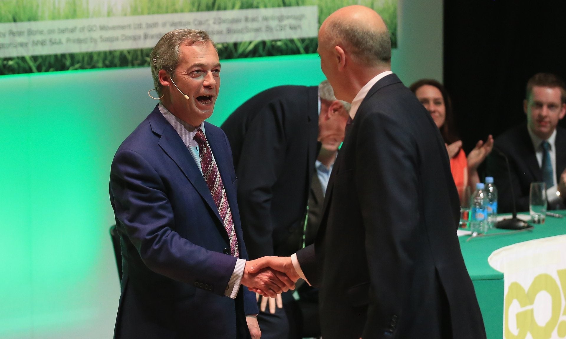 Chris Grayling and Nigel Farage shake hands on stage at Grassroots Out rally in Stoke.
