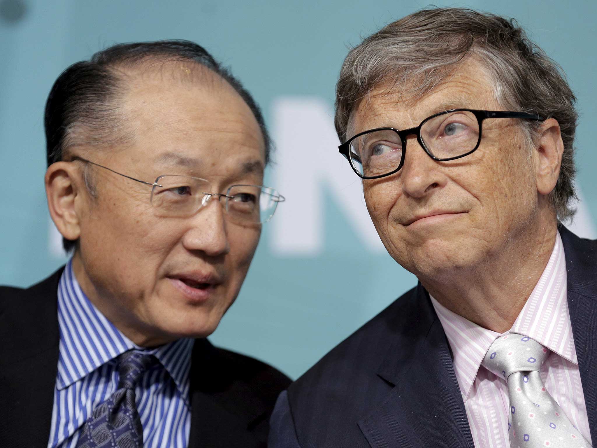 World Bank President Jim Yong Kim speaks with Microsoft co-founder Bill Gates at a forum on financial development at the 2016 IMF World Bank Spring Meeting in Washington