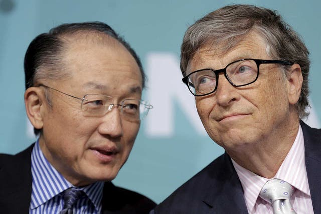 World Bank President Jim Yong Kim speaks with Microsoft co-founder Bill Gates at a forum on financial development at the 2016 IMF World Bank Spring Meeting in Washington