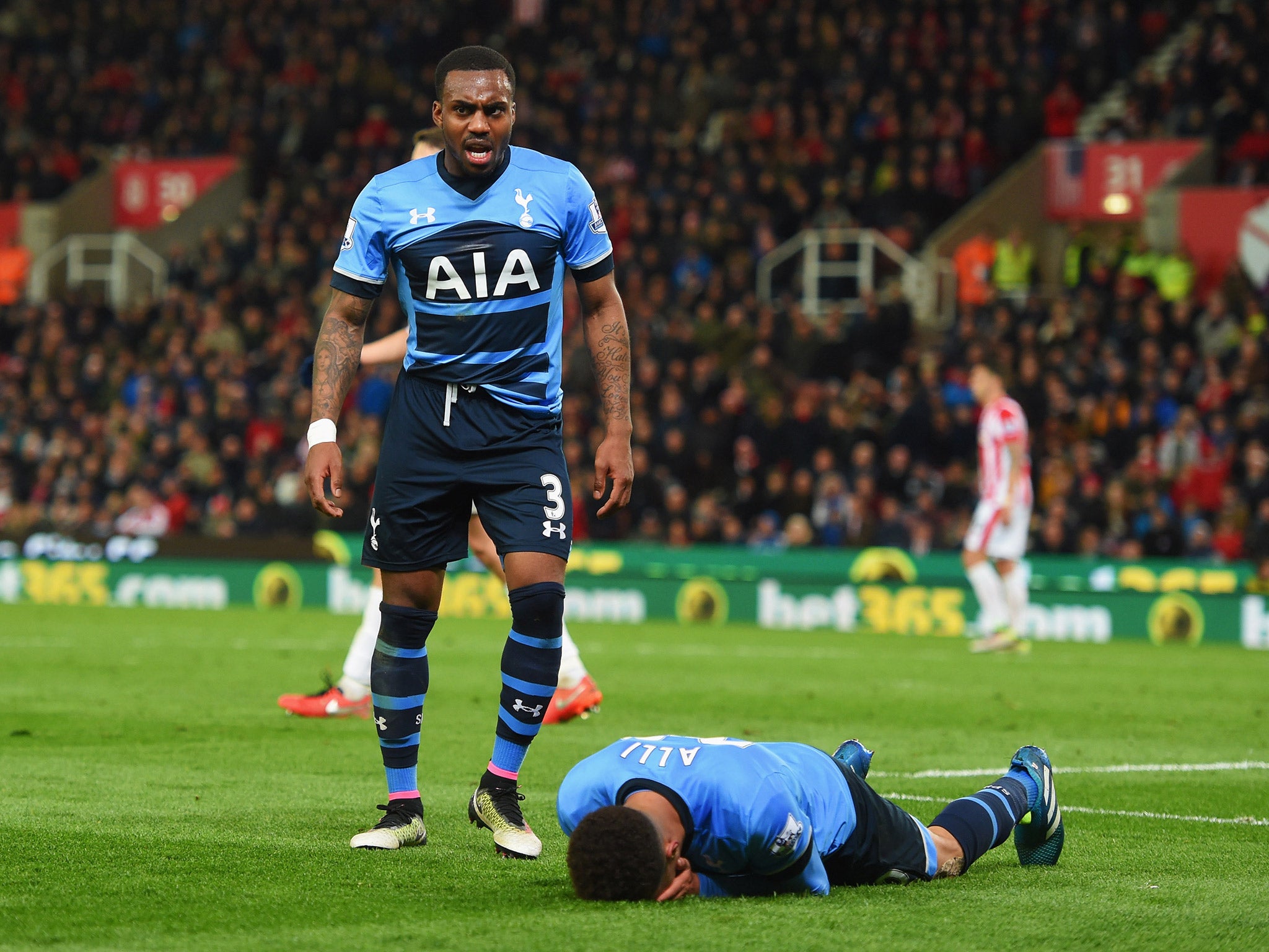 Alli lies prone on the floor after missing a chance to score