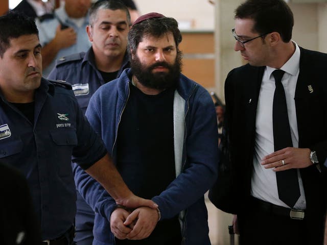 Israeli Yosef Haim Ben-David (C), the ringleader of the killing of Palestinian teenager Mohammed Abu Khdeir last year, is escorted by Israeli policemen at the district court in Jerusalem on April 19, 2016.