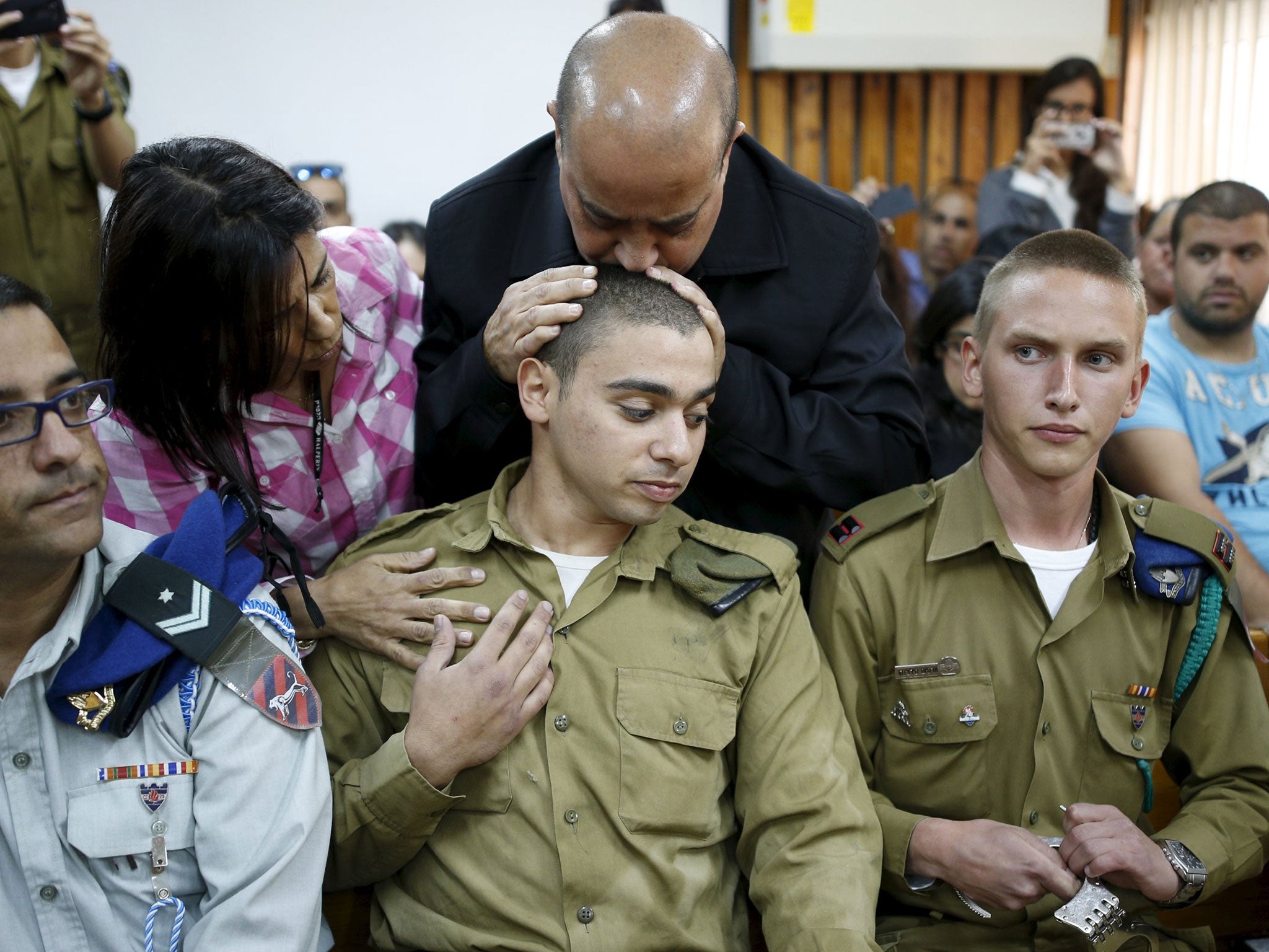 Elor Azaria is embraced by relatives at a 31 March court hearing over the death of a Palestinian man