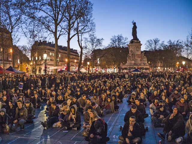 People participate in a sit-in protest organised by the Nuit Debout movement in Paris on Tuesday night