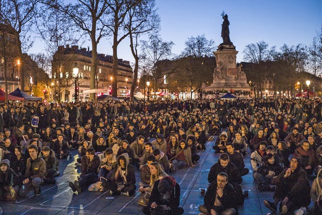 People participate in a sit-in protest organised by the Nuit Debout movement in Paris on Tuesday night