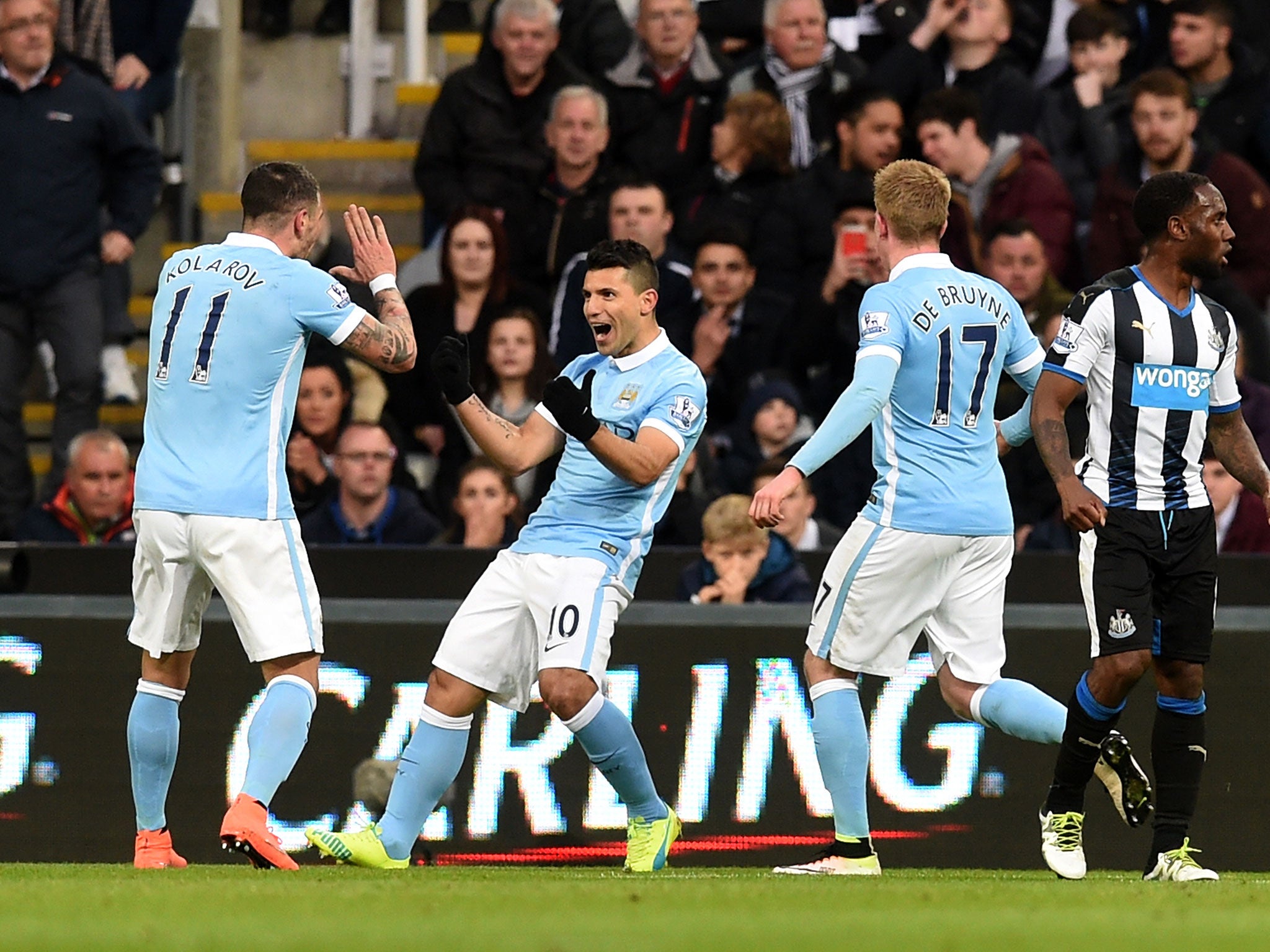 Sergio Aguero (centre) celebrates after opening the scoring