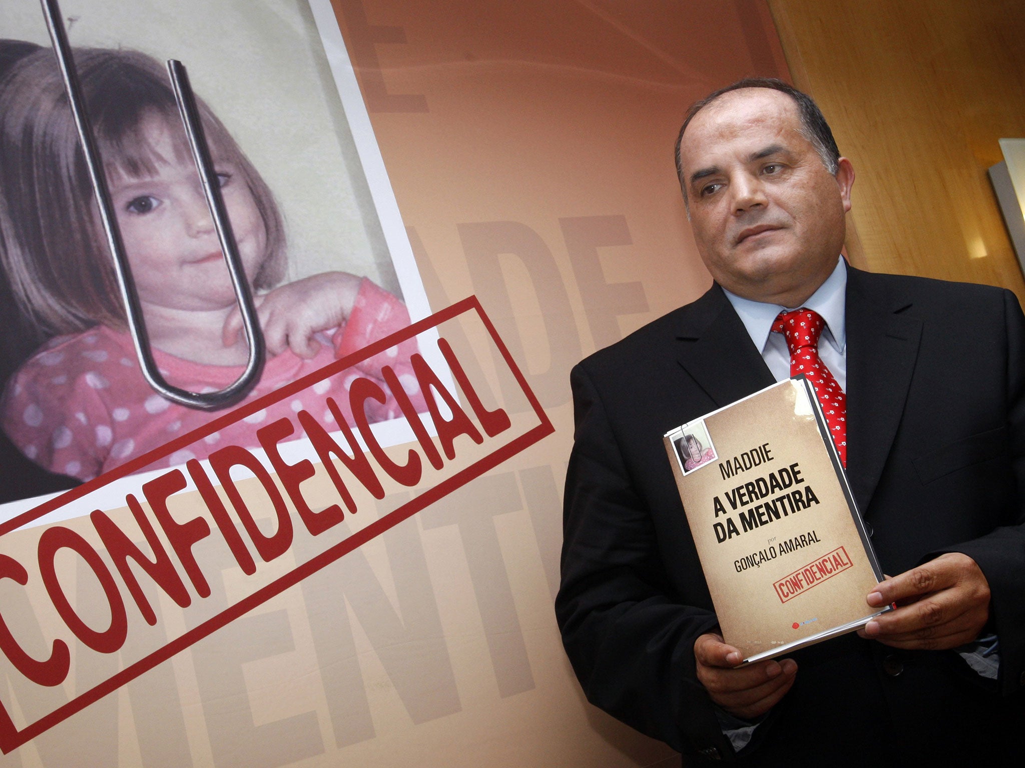 Former detective Goncalo Amaral poses with his book during its launch in Lisbon in 2008