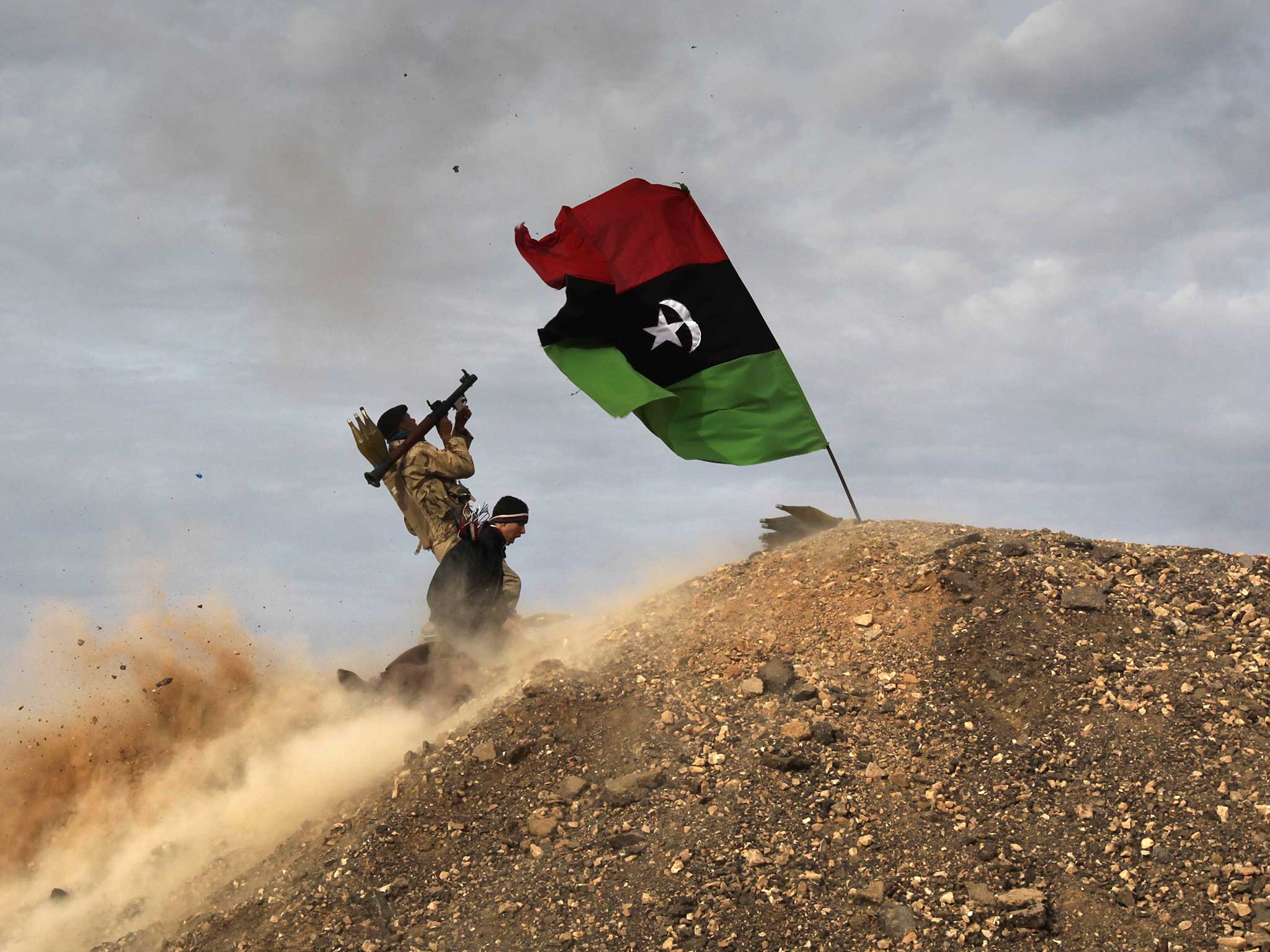 Rebels fire a rocket-propelled grenade at a Libyan air force fighter jet near the Mediterrannean town of Ra’s Lanuf, 2011