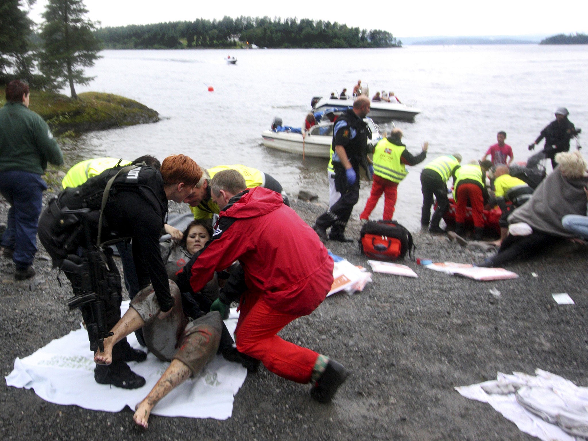 A wounded woman being treated after Anders Breivik's massacre on Utoya island, Norway, on 22 July 2011