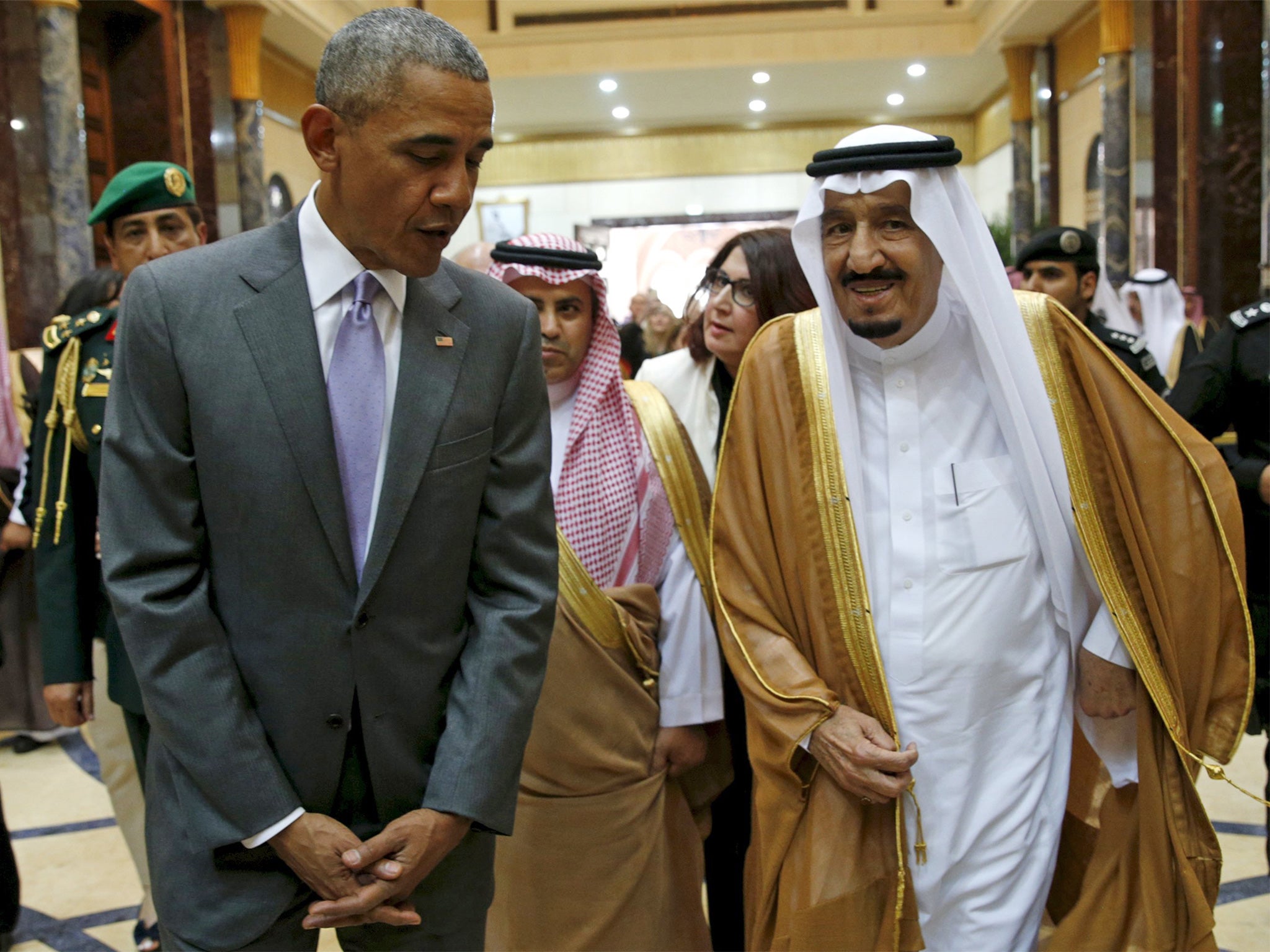 President Obama walks with Saudi King Salman at Erga Palace upon arriving for a summit meeting in Riyadh