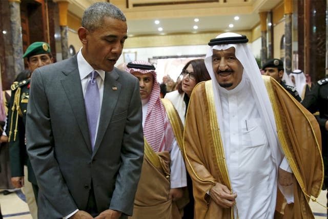 President Obama walks with Saudi King Salman at Erga Palace upon arriving for a summit meeting in Riyadh