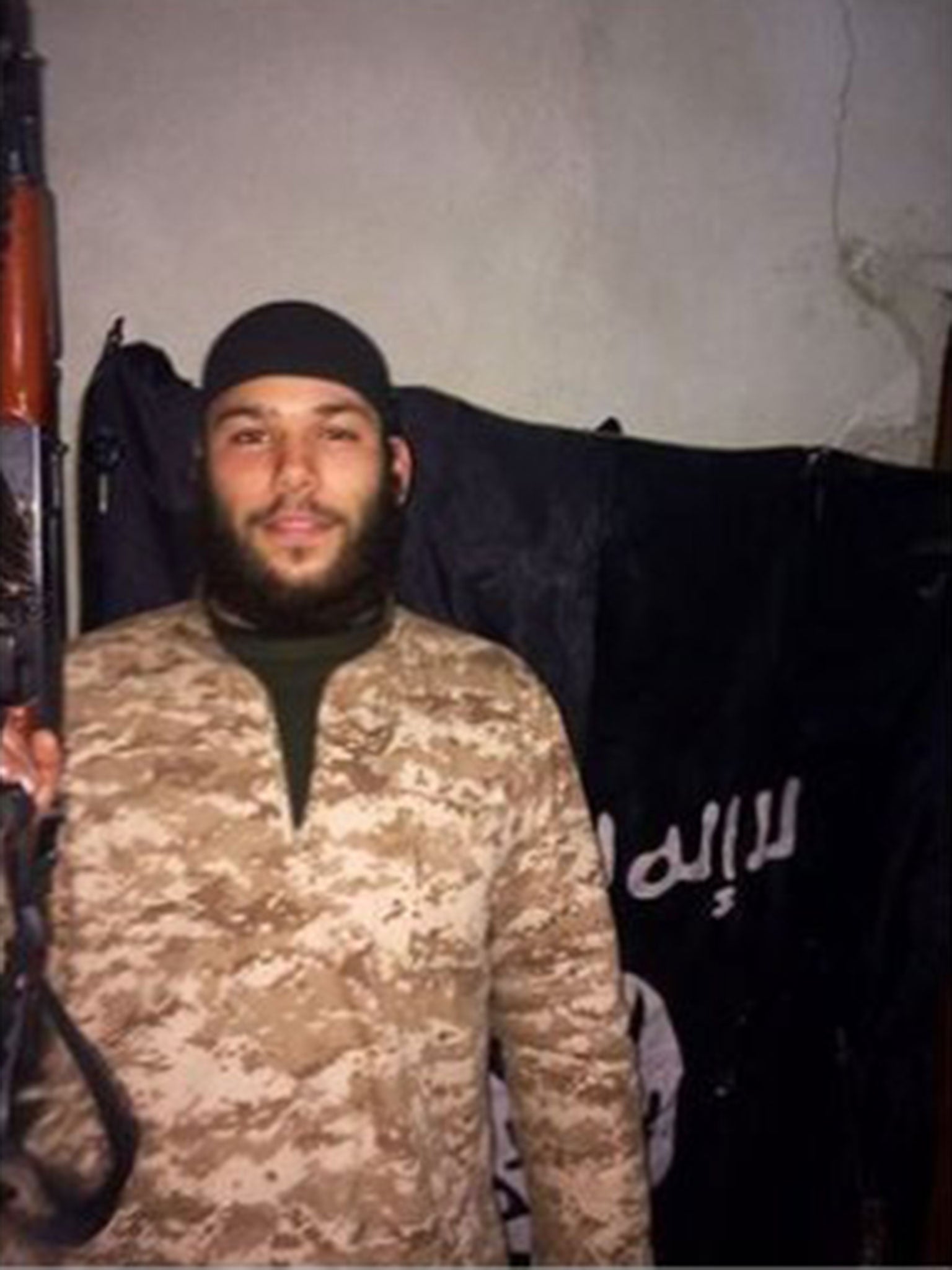 A photo posted on Osama Krayem's Facebook page appearing to show him in Syria with a gun and Isis flag