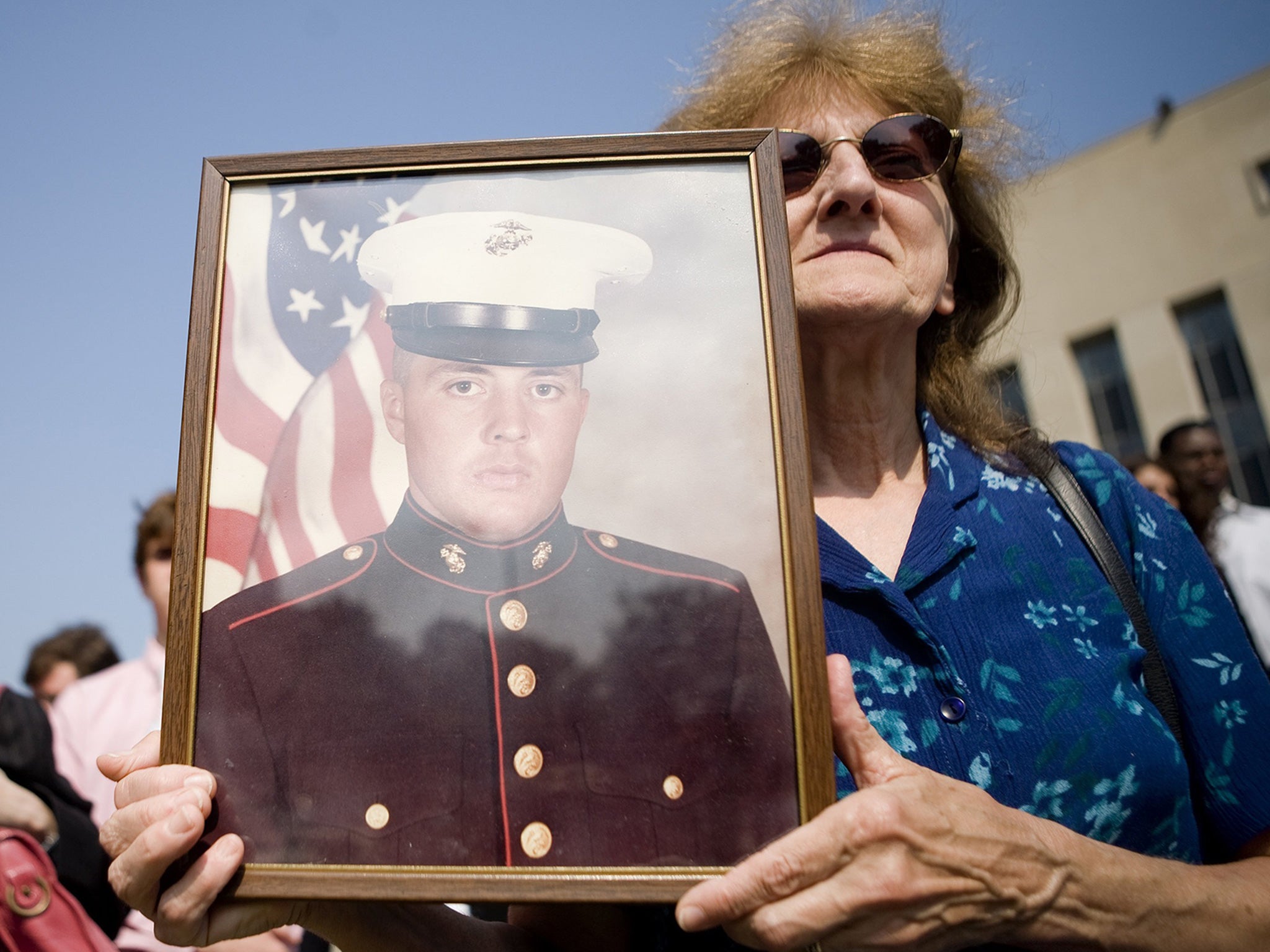 A mother holds a photo of her son who died in the bombing of the US Marine barracks in 1983, outside federal court in Washington in 2007