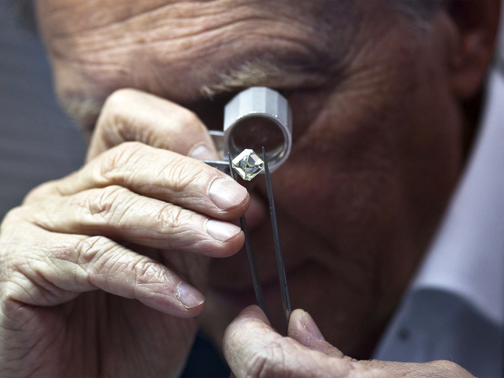 A trader inspects a diamond during a show at the IDE in Ramat Gan near Tel Aviv