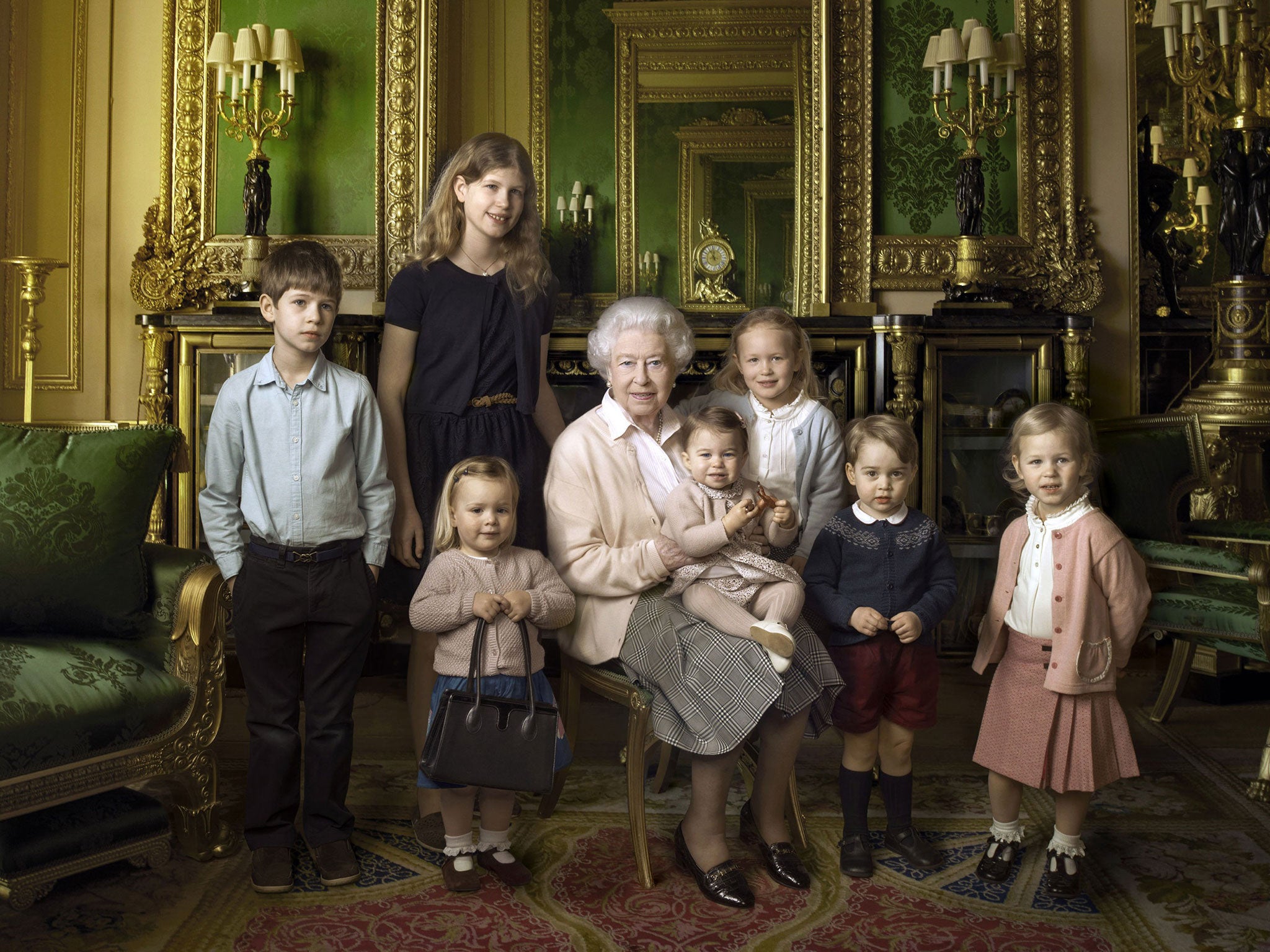An official photograph, released by Buckingham Palace to mark her 90th birthday, shows Queen Elizabeth II with her five great-grandchildren and her two youngest grandchildren at Windsor Castle