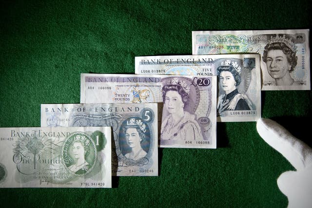 British Pound Sterling banknotes featuring Britain's Queen Elizabeth II are displayed during a photo call  (AFP/Stringer)