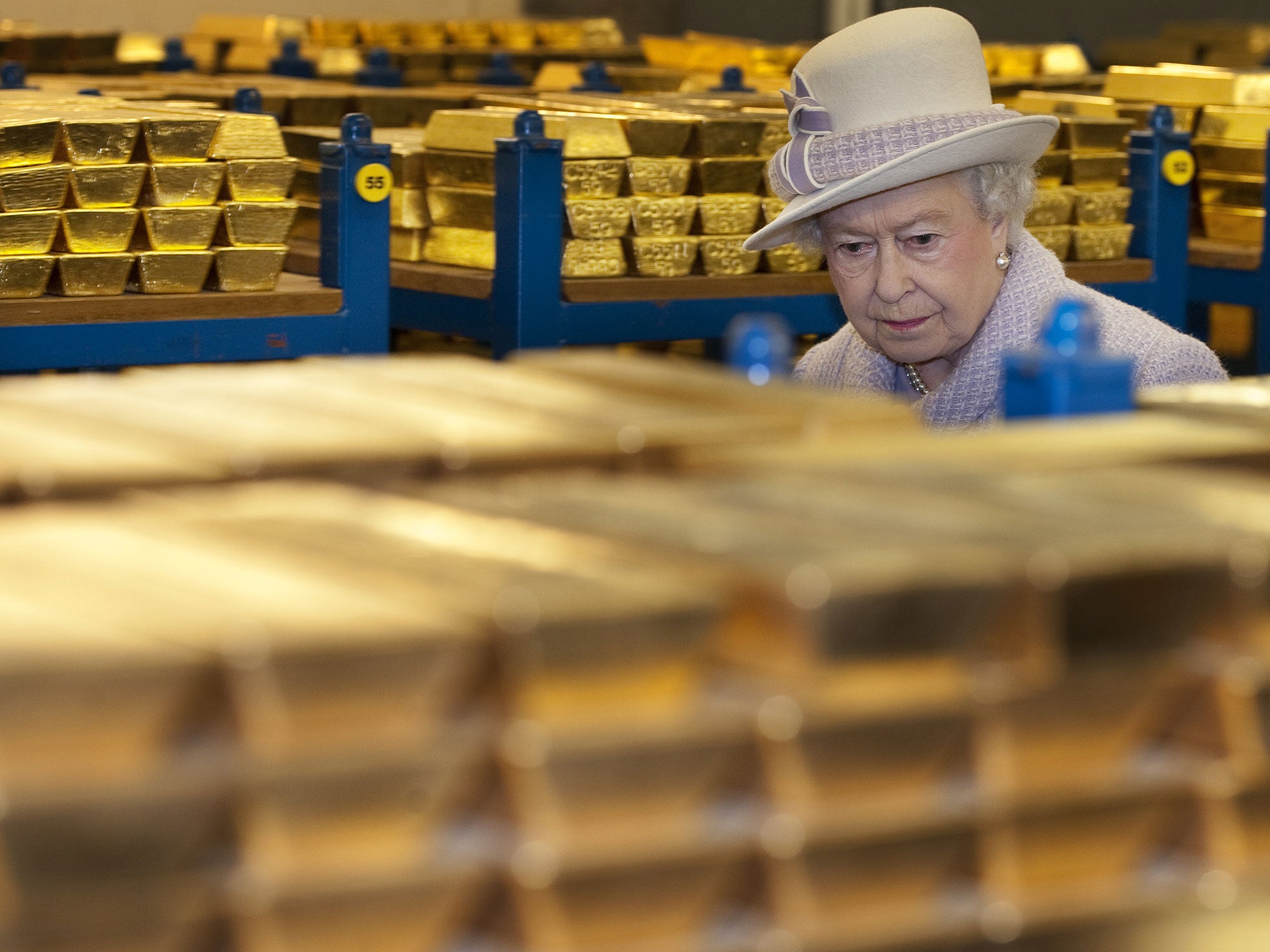 Queen Elizabeth II views stacks of gold as she visits the Bank of England with Prince Philip, Duke of Edinburgh on December 13, 2012 in London, England