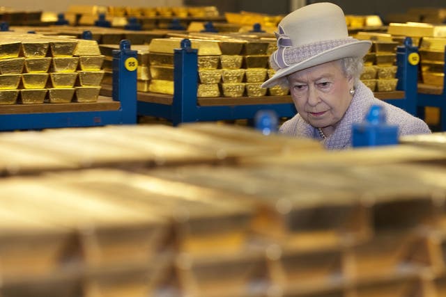 Queen Elizabeth II views stacks of gold as she visits the Bank of England with Prince Philip, Duke of Edinburgh on December 13, 2012 in London, England
