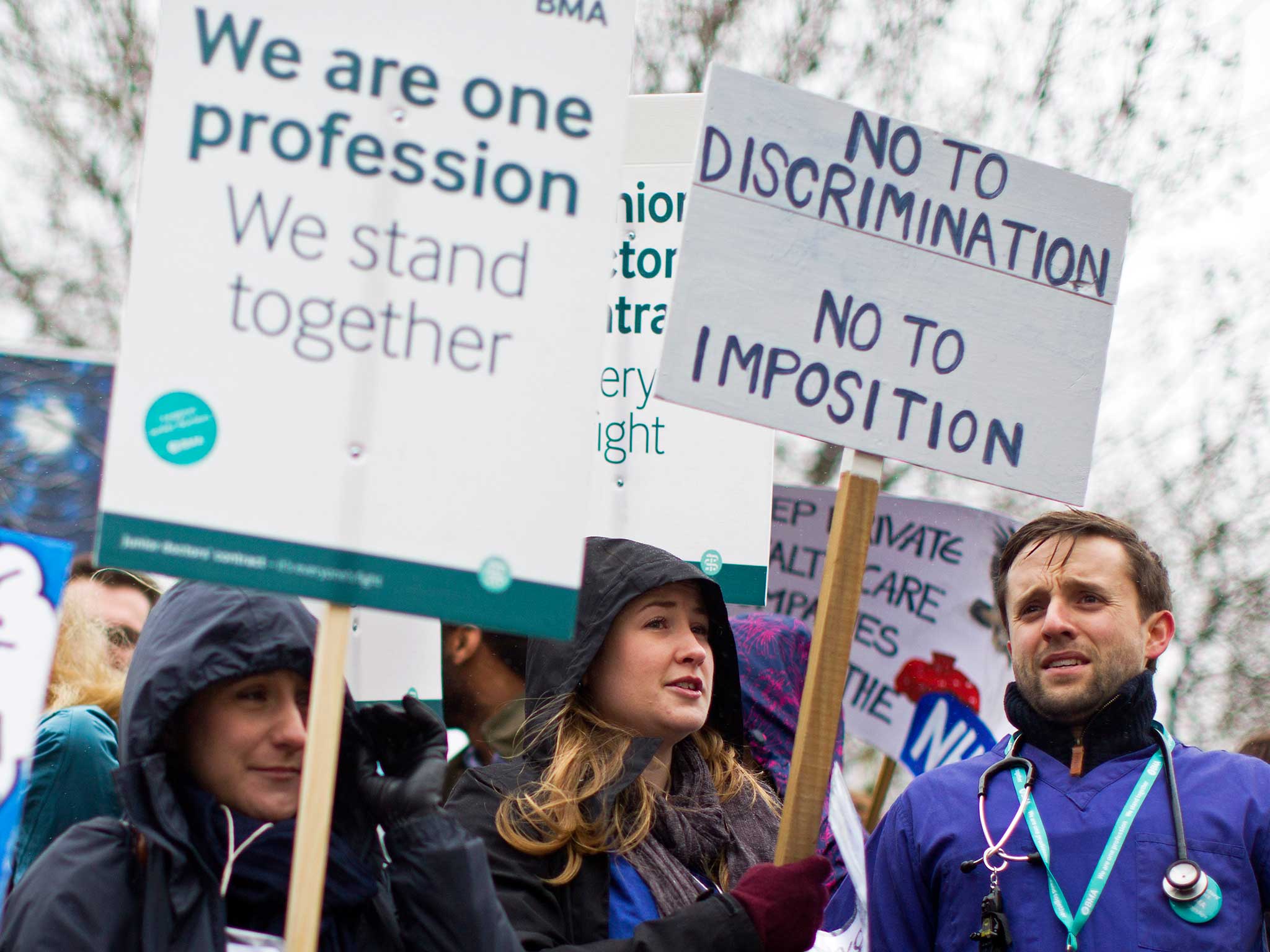 Demonstrators hold placards as they protest during a Junior Doctors' strike outside St Thomas' Hospital in central London