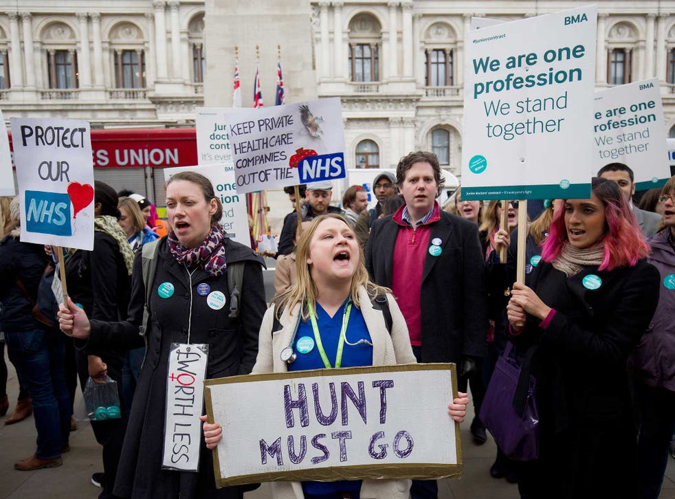 Demonstrators hold placards including one that reads 'Hunt must go', referring to British Health Secretary Jeremy Hunt, during a protest by striking junior doctors outside the Department of Health in central London