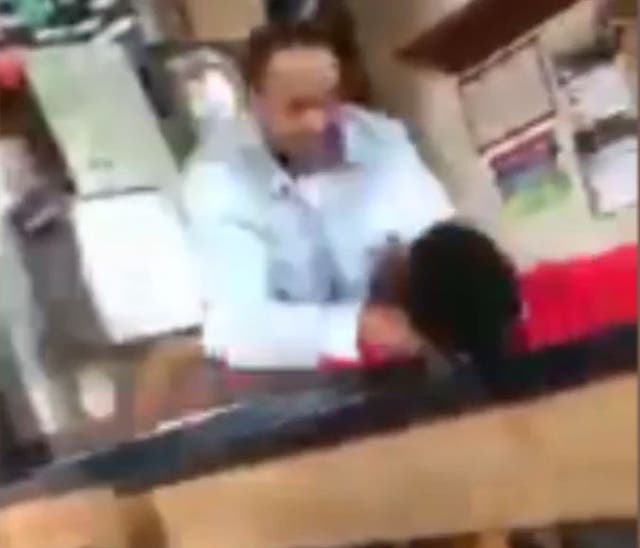 The teacher's assistant put his hands around the boy's throat and shoved him to the ground