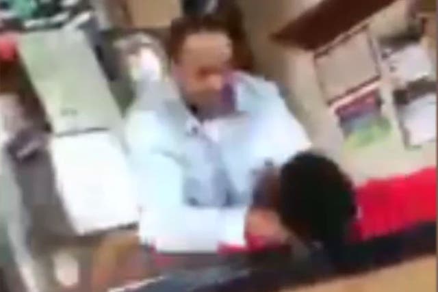 The teacher's assistant put his hands around the boy's throat and shoved him to the ground