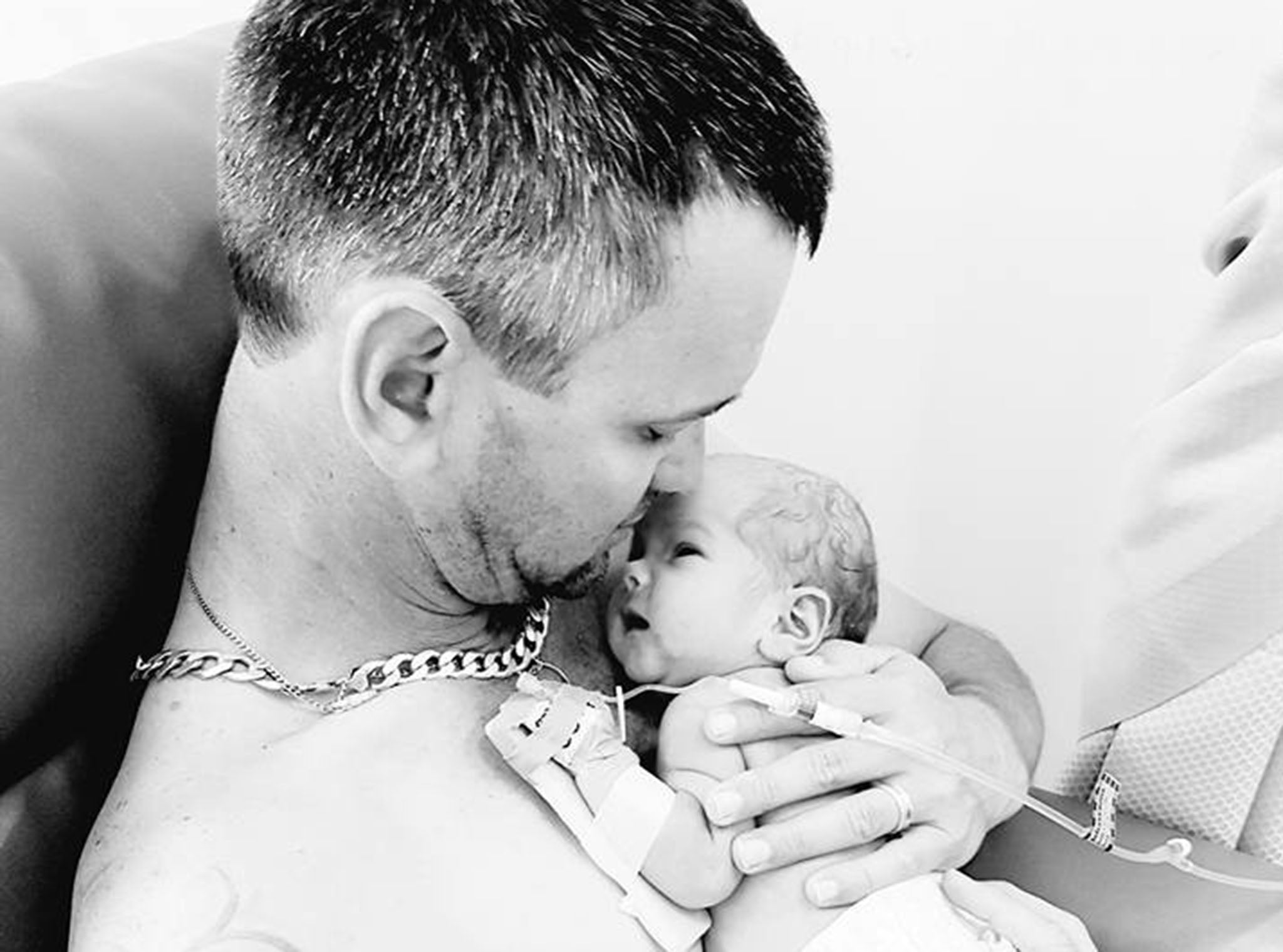 Father pictured bonding with newborn baby after mother dies in