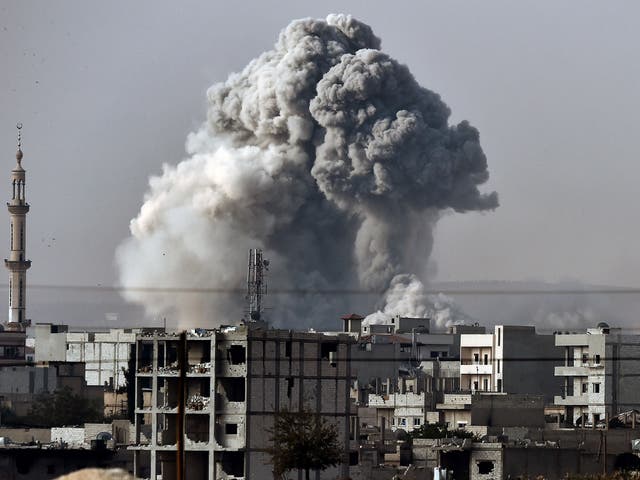 Smoke rises from the the Syrian town of Ain al-Arab, known as Kobane by the Kurds, after a strike from the US-led coalition as it seen from the Turkish-Syrian border in the southeastern village of Mursitpinar, Sanliurfa province, on October 14, 2014.