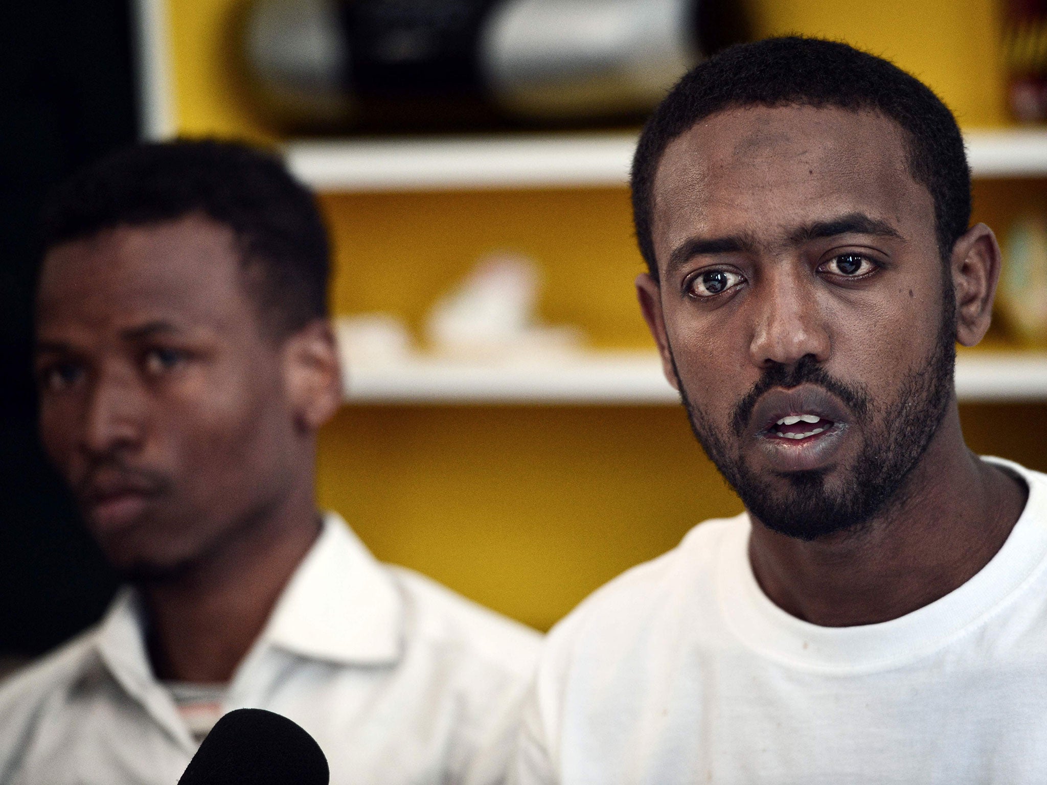 Survivors of a deadly shipwreck, Ismam Mowlid of Somalia (L) and Mahmud Muaz of Ethiopia in Athens on 21 April