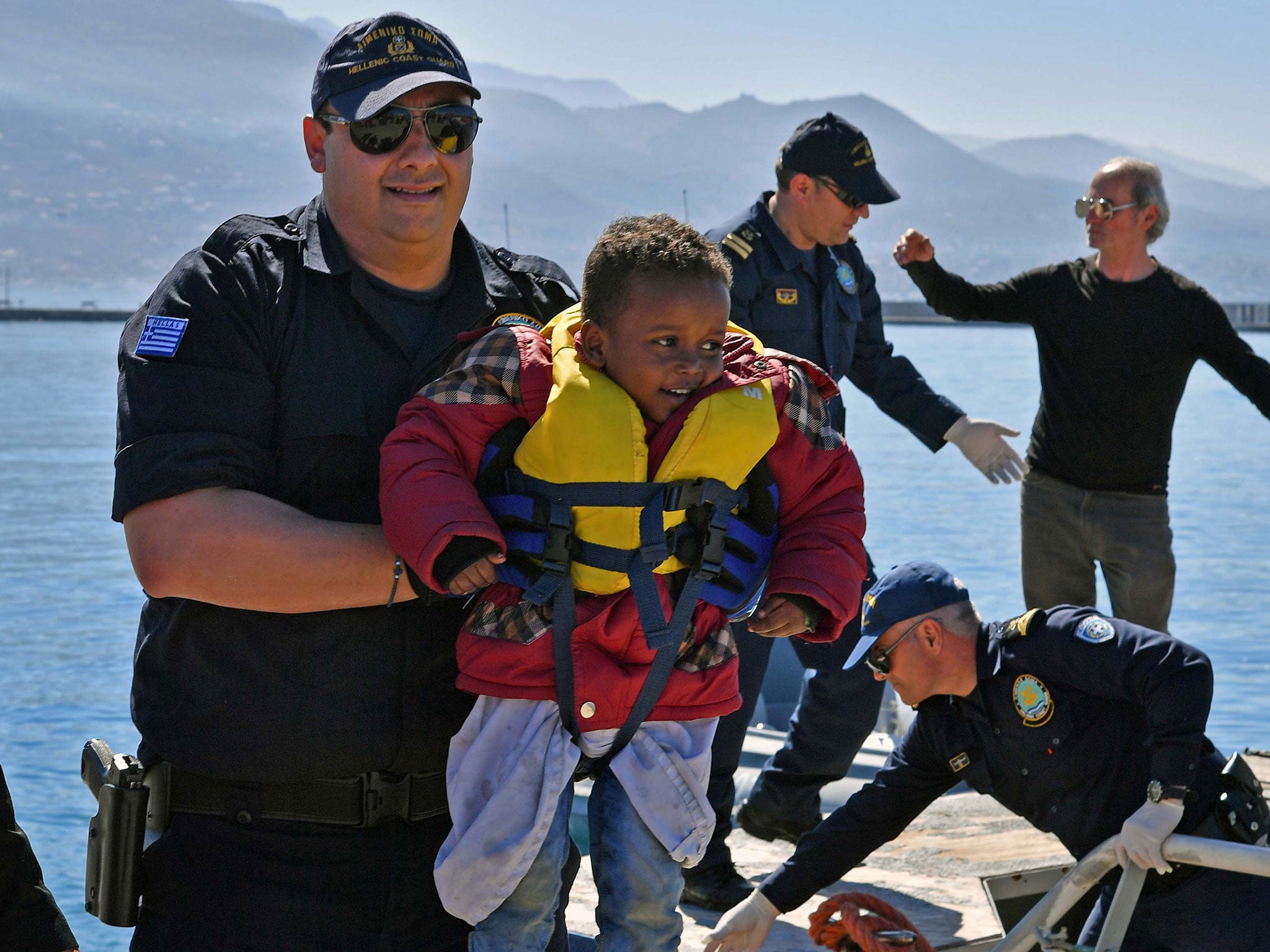 Coast guard members help survivors to disembark at the port of Kalmata in South Peloponnese, Greece, 17 April 2016.