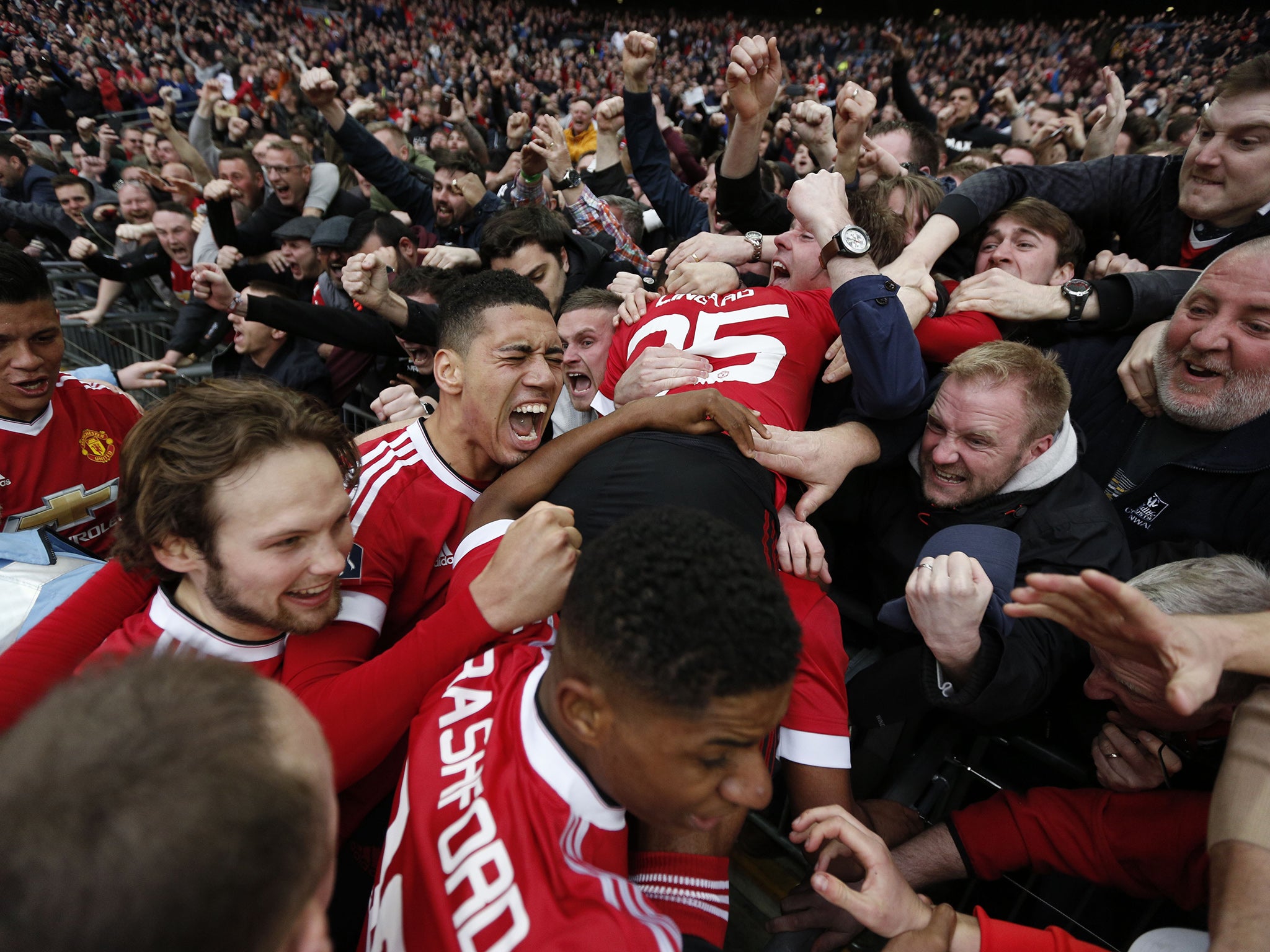 United players celebrate Martial's late winner with their fans