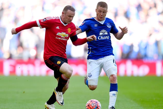 Wayne Rooney battling in midfield with Everton's James McCarthy