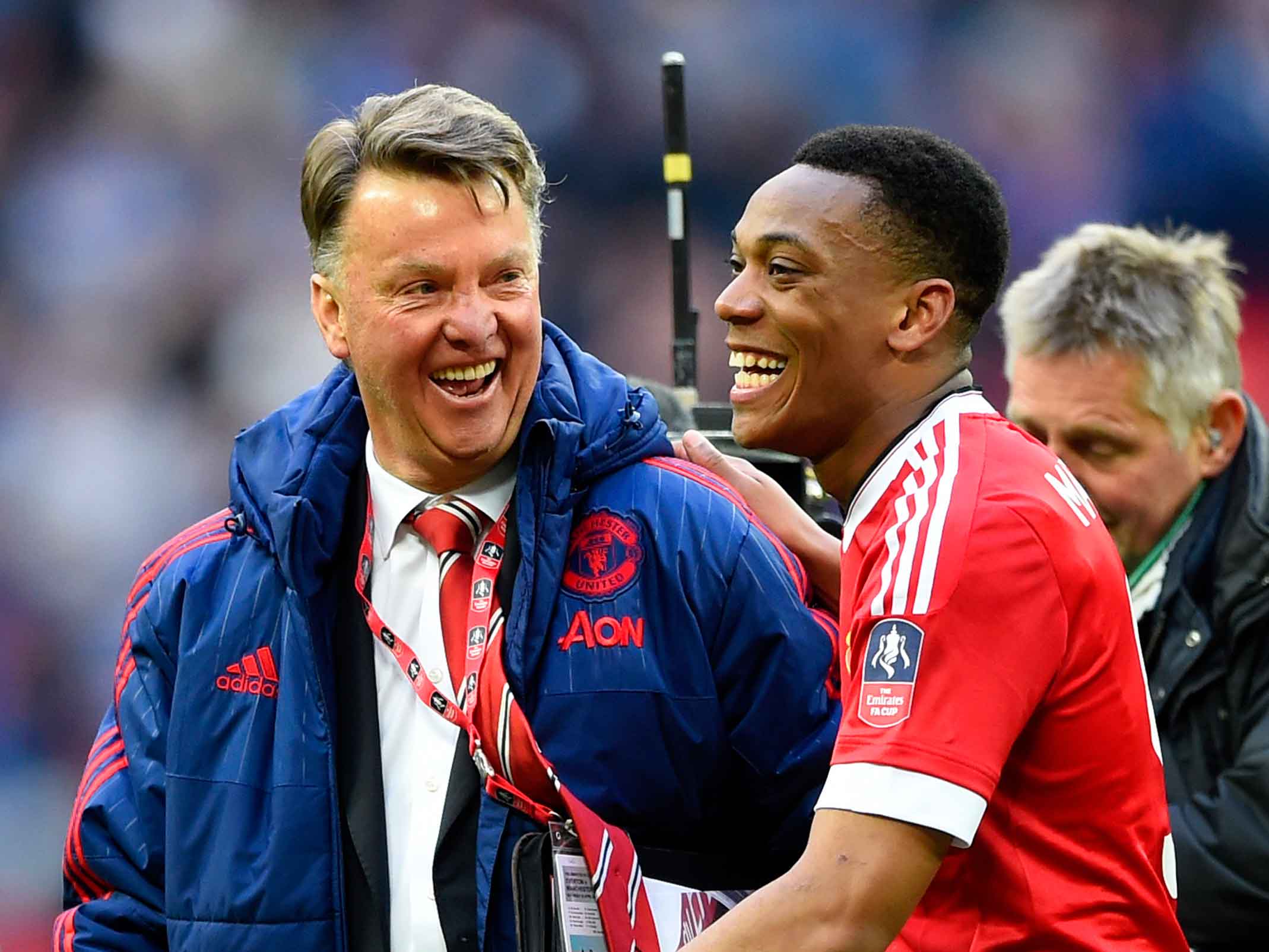 Manchester United manager Louis van Gaal shares a joke with Anthony Martial