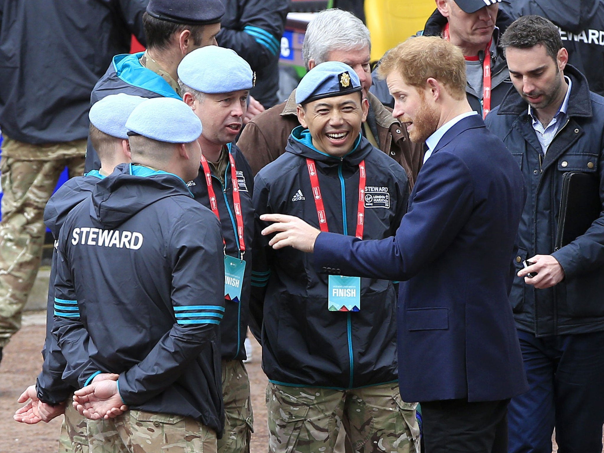 Prince Harry speaks with stewards during the 2016 Virgin Money London Marathon