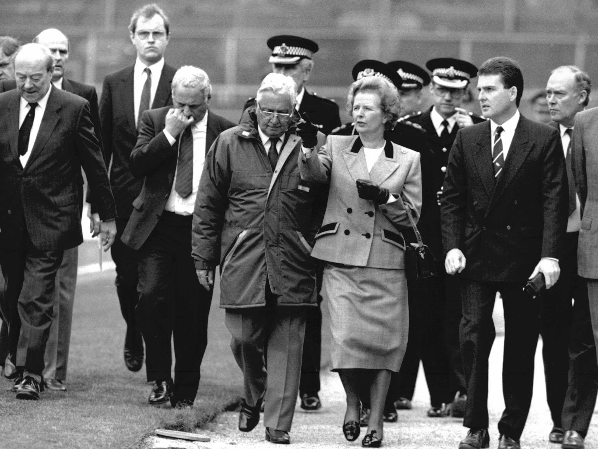 Prime Minister Margaret Thatcher tours Hillsborough stadium with David Duckenfield (on her left) after the Hillsborough football disaster ()