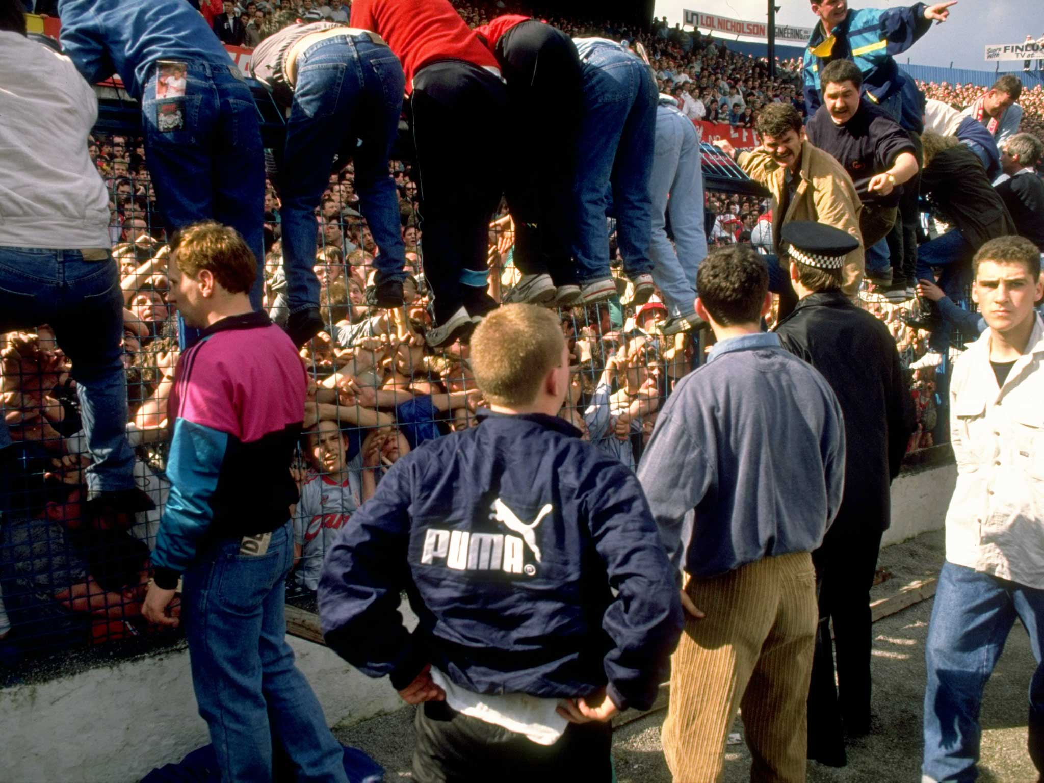 Supporters are crushed against the barrier as disaster strikes before the FA Cup semi-final match between Liverpool and Nottingham Forest played at the Hillsborough Stadium in Sheffield, 1989 (Getty Images)