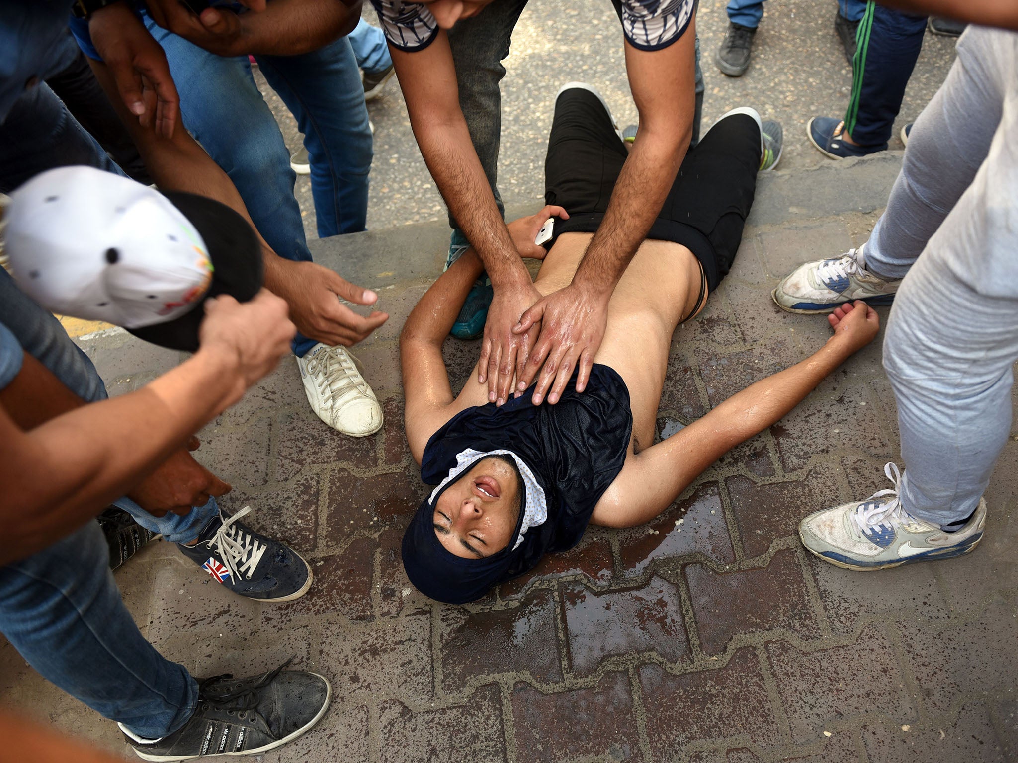 Egyptian police fired tear gas at protesters who held a rally calling for the 'downfall' of the regime