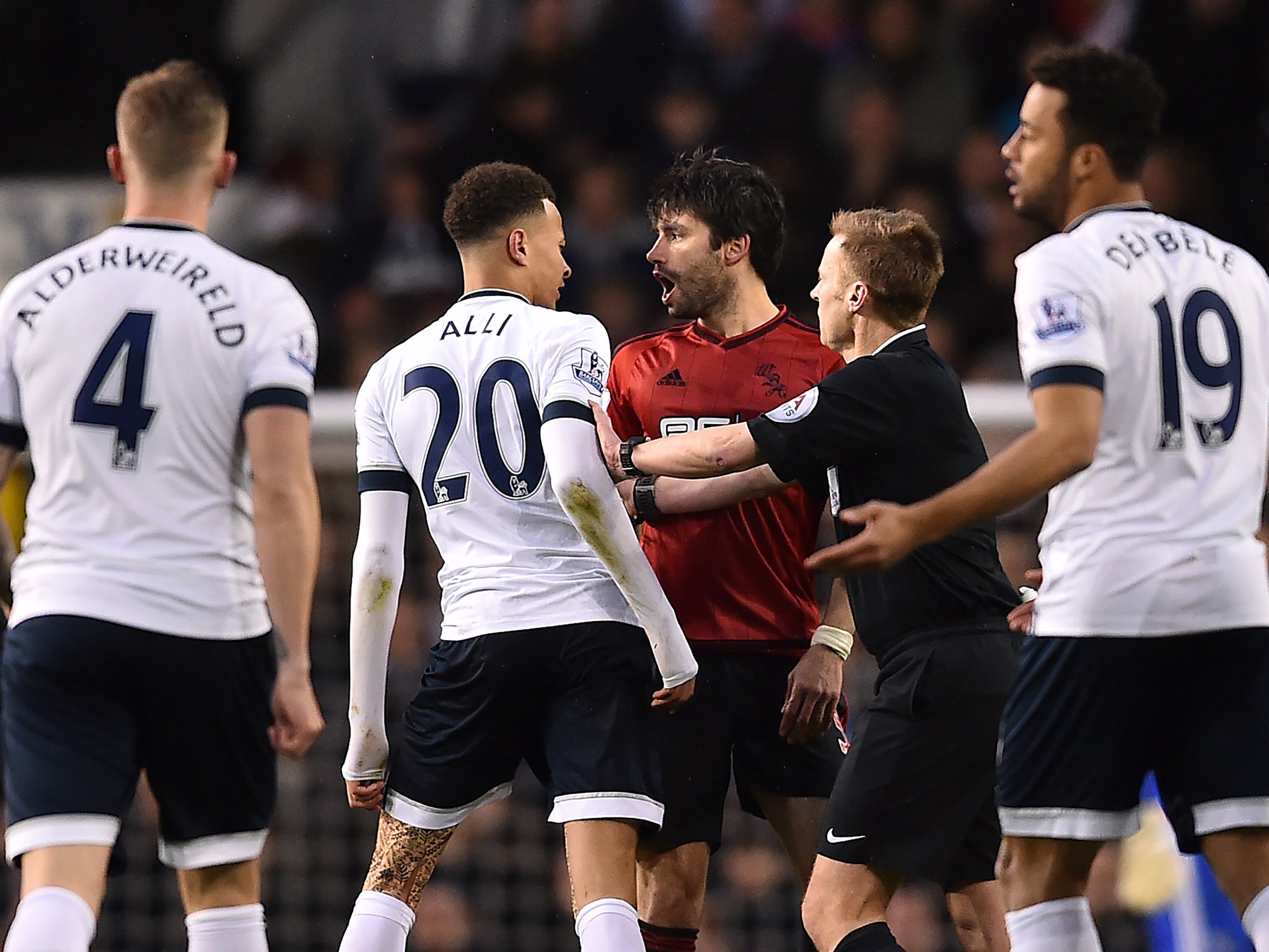 &#13;
Alli reacted to a string of strong tackles from Yacob &#13;