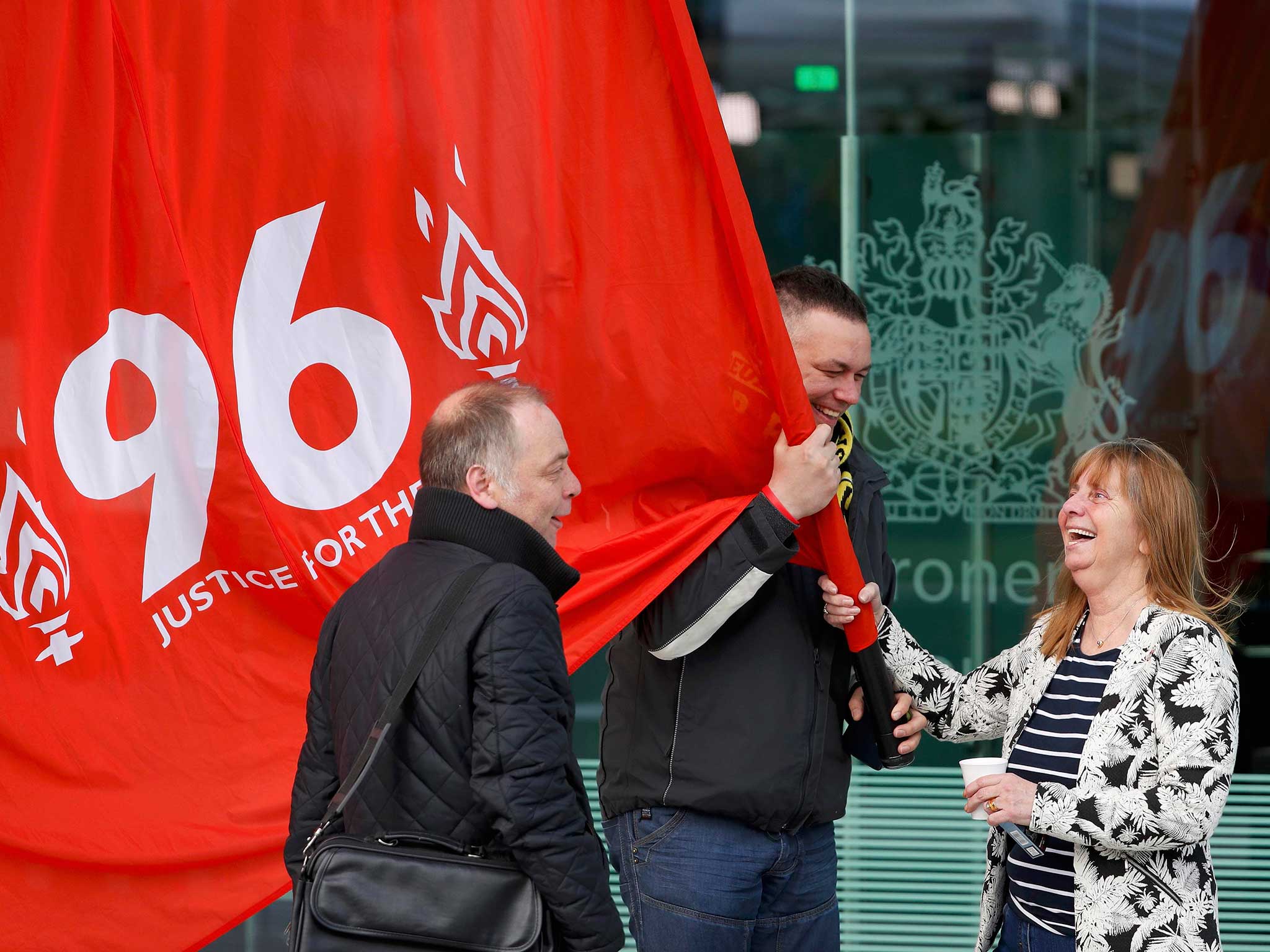 Margaret Aspinall holds a banner after the jury delivered its verdict at the new inquests into the Hillsborough disaster