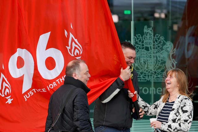 Margaret Aspinall holds a banner after the jury delivered its verdict at the new inquests into the Hillsborough disaster